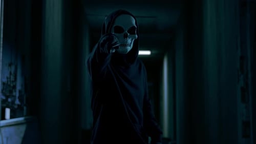 Hooded Masked Person Points Knife in Dark Corridor