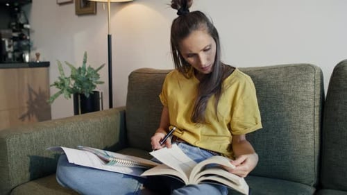 Woman Studying and Reading Book Indoors