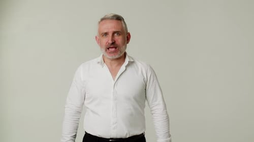 Frustrated Man Expressing Negative Emotions in Studio