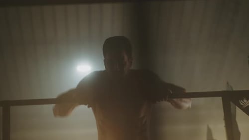 Shirtless Man Doing Pull-Ups in Gym