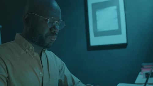 Man Working on Laptop at Home during Night