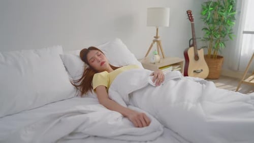 Woman Sleeping Peacefully in Bed at Home