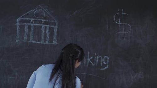 The woman who writes Banking on the blackboard looks up with a sad expression.