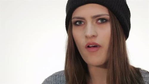 Young Woman Chewing and Making a Disgusted Face