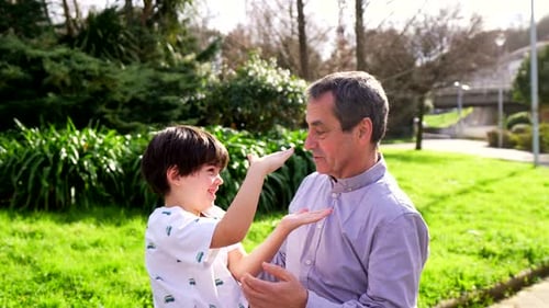 Grandfather and Grandson Playing in the Park