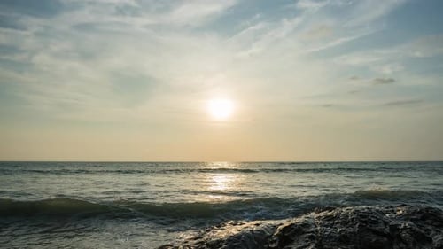 Dramatic sunset with orange sky in a cloudy day at a tropical beach.