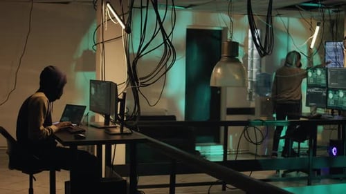 Young Adults Working on Computers in Dark Room