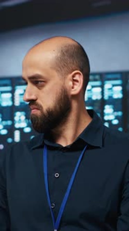 Man Works Diligently In Front of Monitors