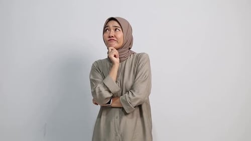 Pensive Woman in Head Covering Deep in Thought