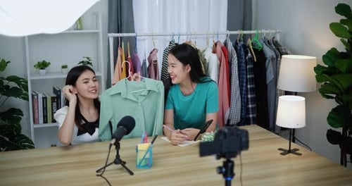 Young Beautiful Asian women live streaming sale clothes at shop