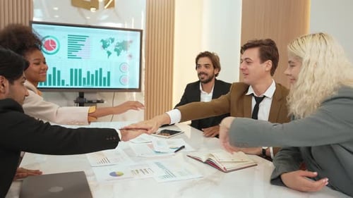 Group of diverse office worker join hand together in ornamented office room