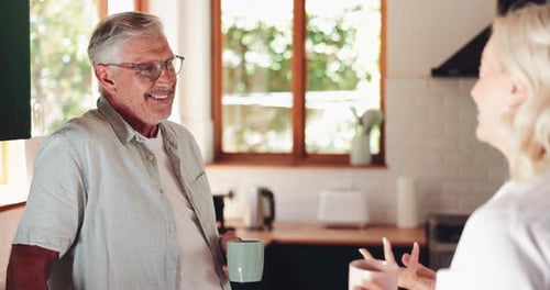Senior Couple Conversing in Sunny Kitchen