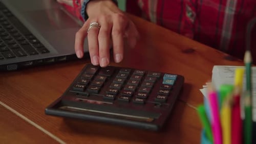 Close up of hand using a calculator