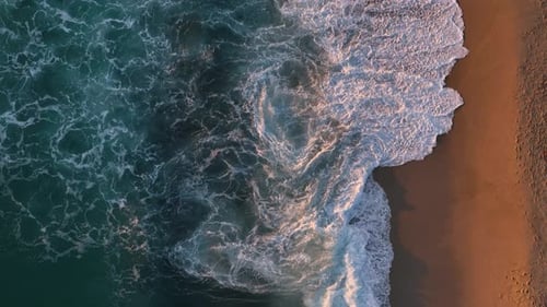 Slow Motion of Foamy Waves Rolling Towards the Sand Beach Golden Beach Top Down View
