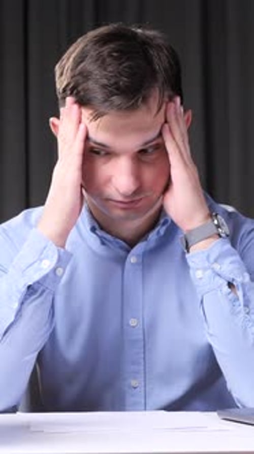 Vertical Video Stressed Office Worker Suffering From Headache at Workplace
