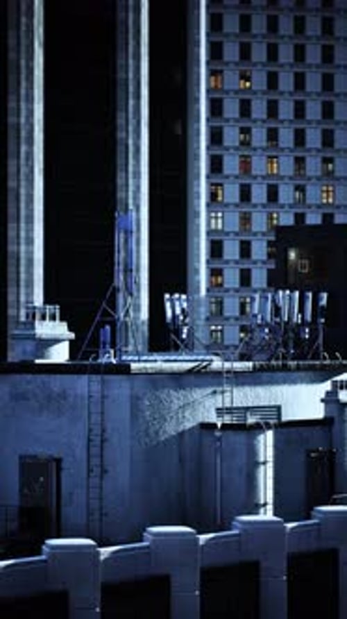 Rooftop View of City Buildings Under a Twilight Sky Filled with Antennas