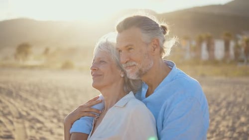 Mature married couple in love bonding outdoors at the beach