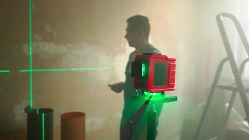 Green Beam of Laser Roulette is Displayed on Brown Wall