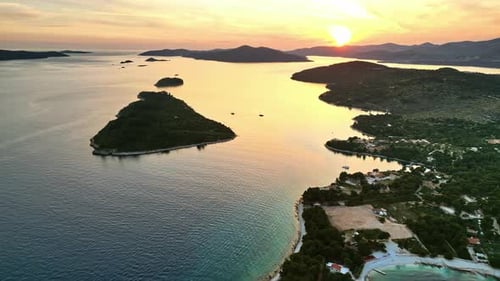 Aerial, drone view of land on the shore of the Adriatic sea in Croatia, at sunset