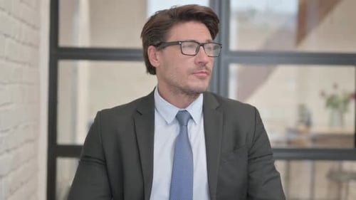Professional Man Checking Watch in Office Setting