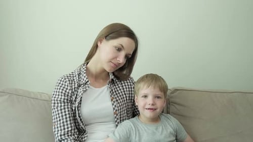 Mother and Child Sitting on Couch Chatting