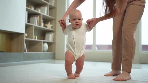 Adorable Baby Learns to Walk with Assistance