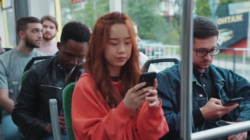 A City Bus Filled with People Absorbed in Smartphones Showing Connectivity
