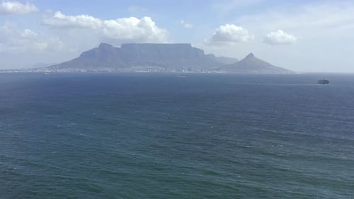 4k video footage of the ocean with a mountain in the background in Cape Town, South Africa