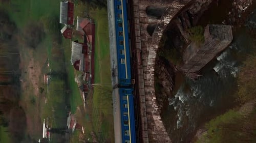 Train passing through mountain viaduct bridge
