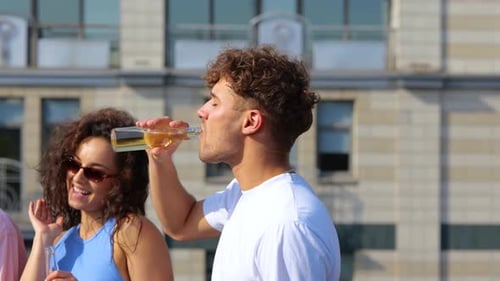 Young Adults Drinking Beverages Together in the City