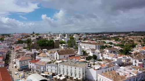 View on historic town of Tavira with Roman bridge over River Gilao, Algarve, Portugal. Cityscape of