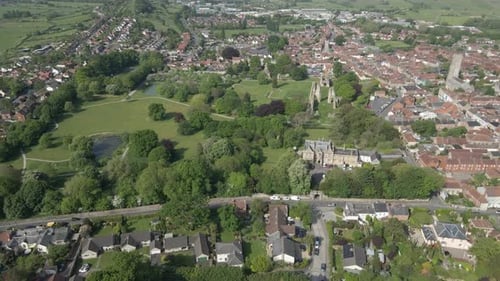 Aerial view of the Glastonbury Abbey ruins an 8th century monastery and gardens. Drone moving forwar