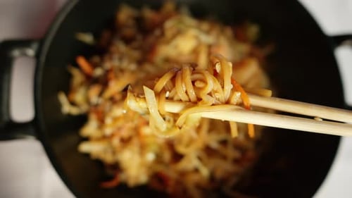 Close up view of wok rice noodles with king prawns and steam served at a traditional japanese restau