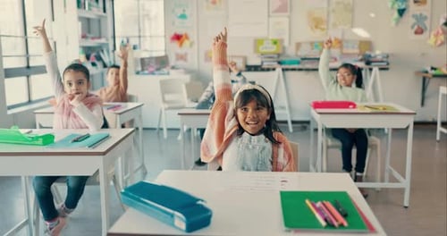 Enthusiastic Students Raising Hands in Classroom