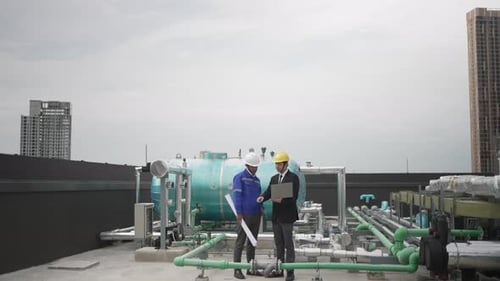 Engineers are checking cooling system at rooftop.