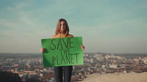 Young Woman Activist Holding Encouraging Green Poster Save the Planet Standing Background Beautiful