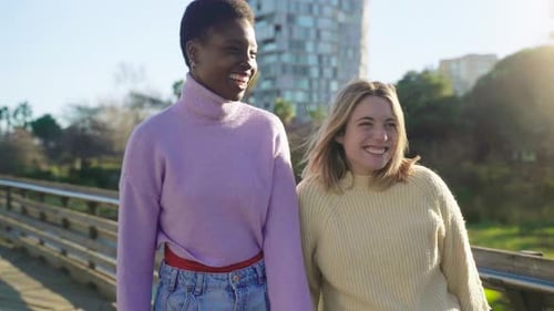 Happy Women Walking Together in City Park
