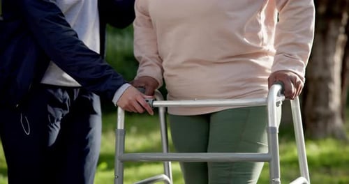 Caregiver Helping Senior Woman With Walker