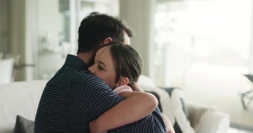 Loving Father Embraces Young Daughter in Living Room
