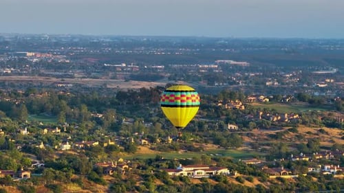 Hot Air Ballooning Over Suburban Landscape