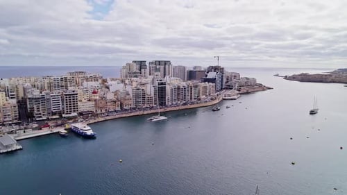 Aerial drone view of Sliema cityscapes in Malta. buildings and seawater.