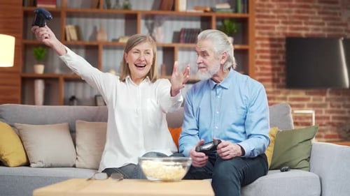 Senior Couple Playing Video Games Together at Home