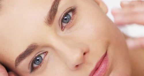 4k video footage of an alluring beautiful woman posing against a studio background