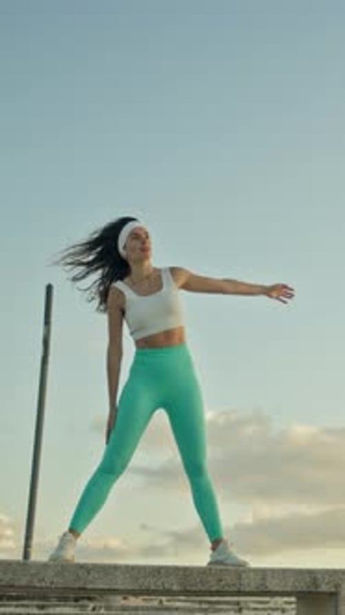 Active Woman Stretching Doing Yoga On Rooftop