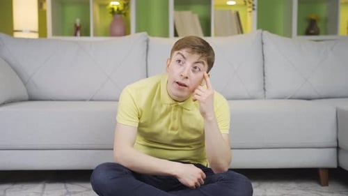 Man Thinking Hard While Sitting on the Floor
