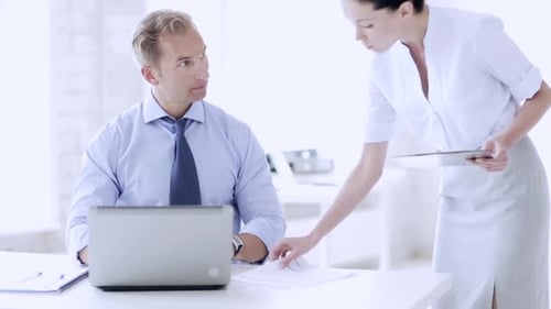 Businessman in tie signs important contract at office desk for new deal