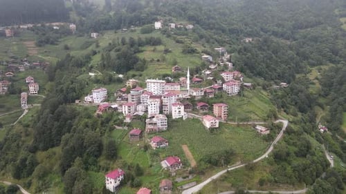 Drone view of the town and mosque built on the hill, the settlement among the greenery