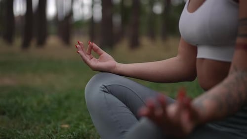 Woman in Lotus Position Meditating Outdoors