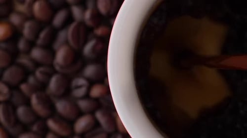 Brewed Coffee is Poured Into an Empty White Coffee Mug Top View