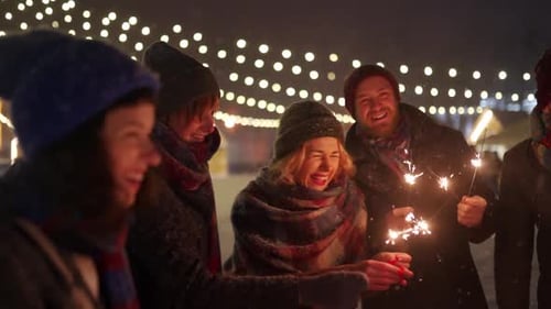 Friends Celebrate Winter Night with Sparkling Sparklers